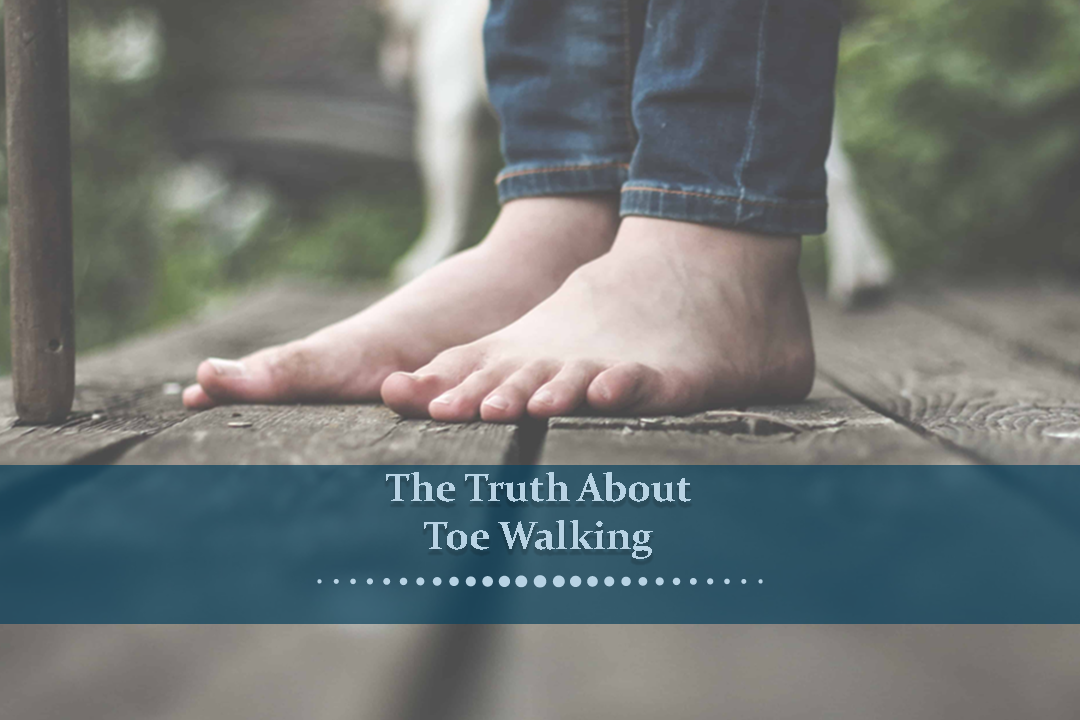 A pair of feet seen standing on top of a brown wooden deck.